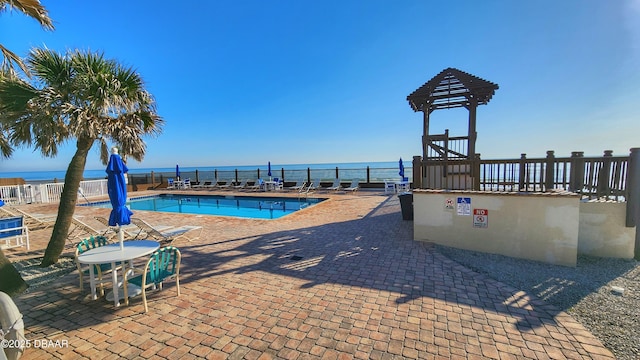 view of swimming pool featuring a water view