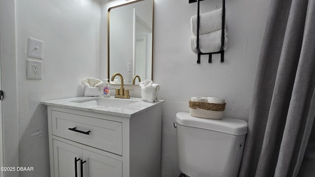 bathroom featuring toilet and vanity