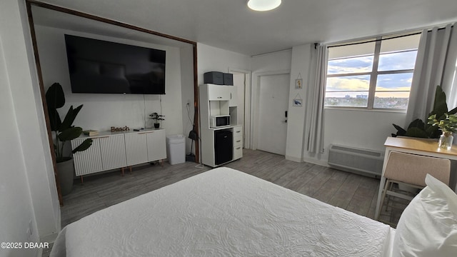 bedroom featuring an AC wall unit and dark hardwood / wood-style floors