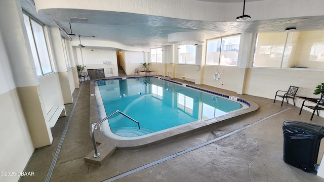 view of swimming pool with a hot tub