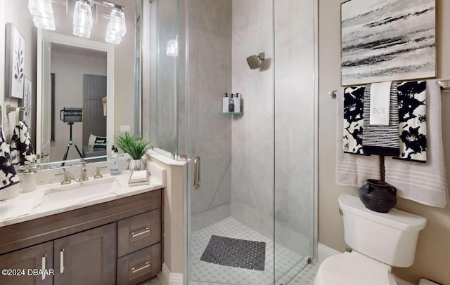 bathroom featuring vanity, toilet, and a shower with shower door