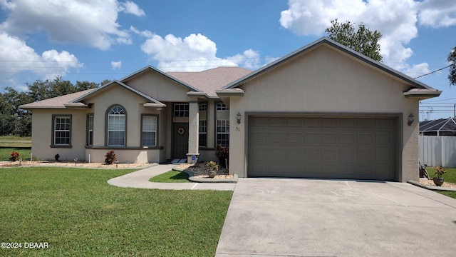 ranch-style house featuring a front yard and a garage