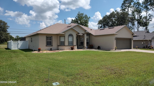 ranch-style house with a garage and a front yard