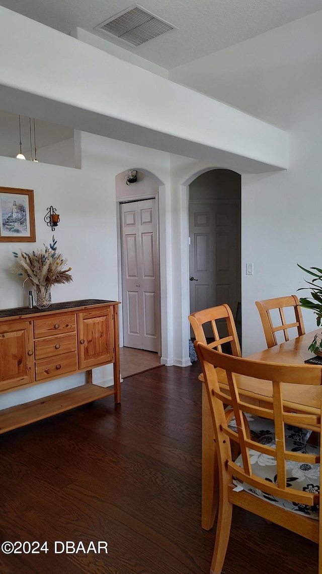 dining space with dark wood-type flooring