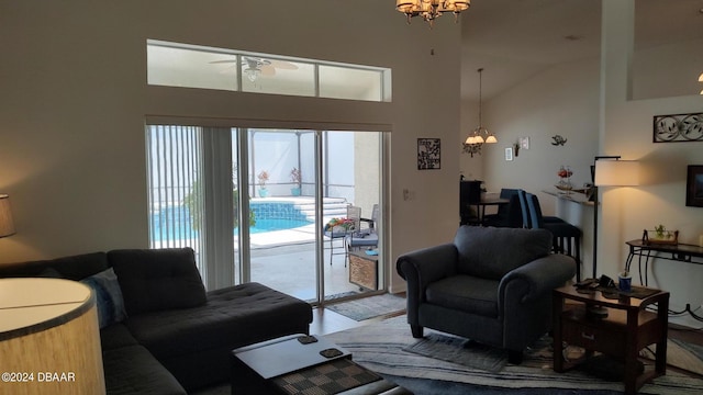 living room with high vaulted ceiling and a notable chandelier