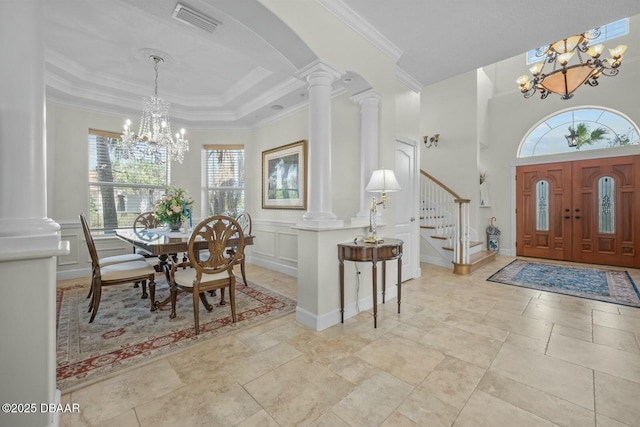 dining area with a healthy amount of sunlight, decorative columns, and a notable chandelier