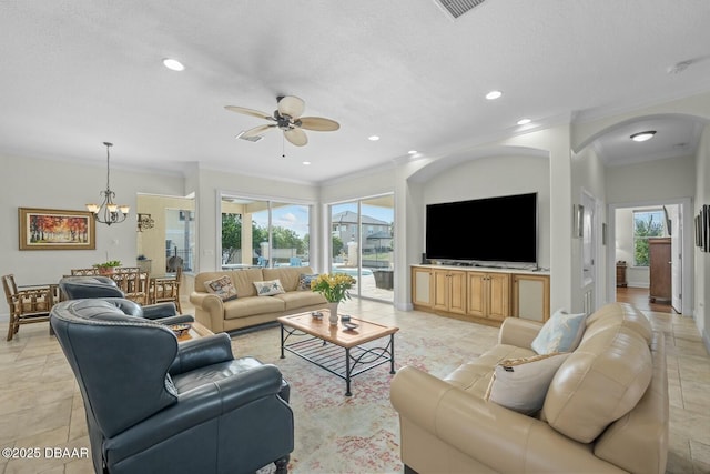 living room with ornamental molding, ceiling fan with notable chandelier, a textured ceiling, and plenty of natural light