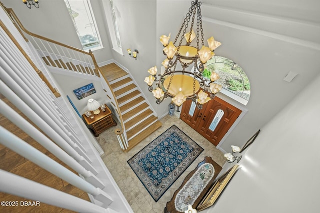 foyer entrance featuring a healthy amount of sunlight and a chandelier