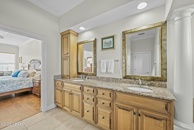 bathroom with crown molding, vanity, tile patterned flooring, and decorative columns