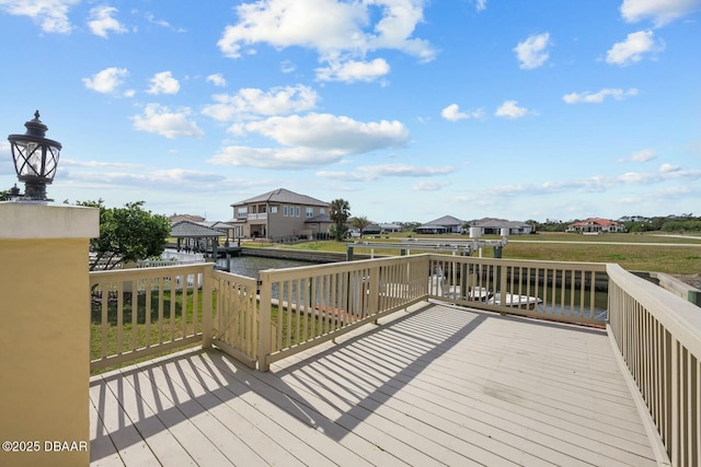 wooden terrace featuring a water view