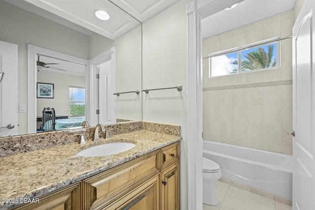 full bathroom with toilet, tiled shower / bath, vanity, ceiling fan, and tile patterned flooring