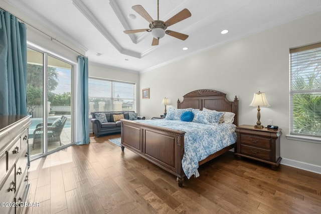 bedroom with crown molding, access to outside, dark hardwood / wood-style floors, a raised ceiling, and ceiling fan