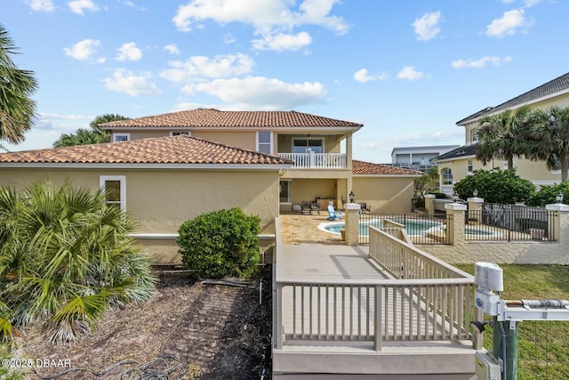 rear view of house featuring a balcony and a patio area