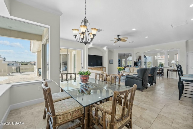 dining area featuring ornamental molding, ceiling fan with notable chandelier, and decorative columns