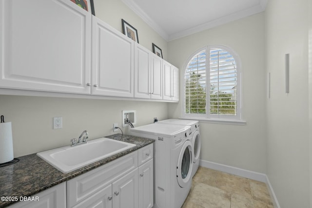 laundry room with sink, crown molding, cabinets, and washing machine and clothes dryer