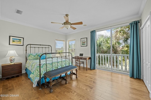 bedroom with crown molding, a closet, ceiling fan, and light wood-type flooring