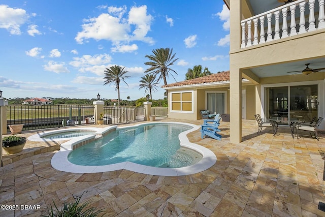 view of swimming pool with an in ground hot tub, ceiling fan, and a patio area