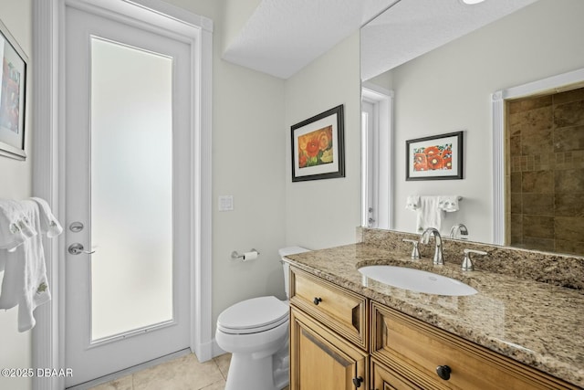 bathroom with vanity, tile patterned floors, and toilet