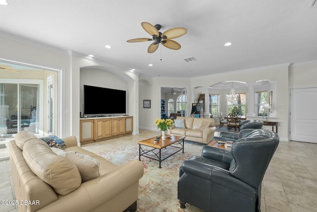 living room featuring crown molding, ceiling fan, and ornate columns