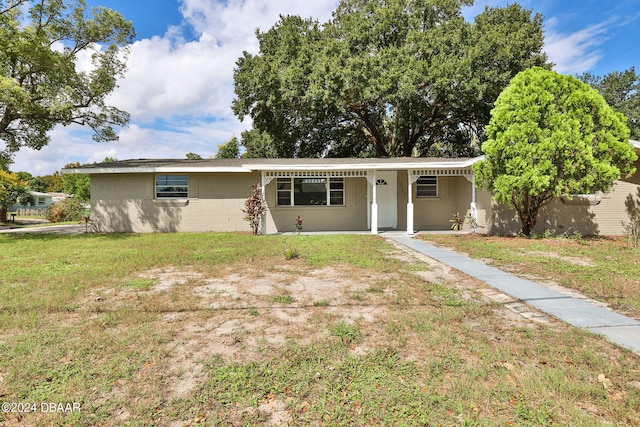 ranch-style house with a front lawn and covered porch