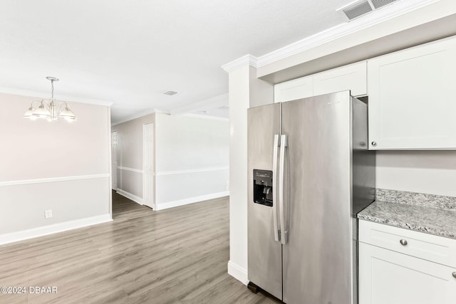 kitchen featuring hardwood / wood-style floors, stainless steel fridge, white cabinetry, and crown molding