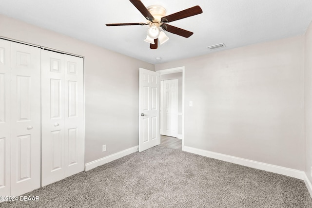 unfurnished bedroom with carpet floors, a closet, and ceiling fan