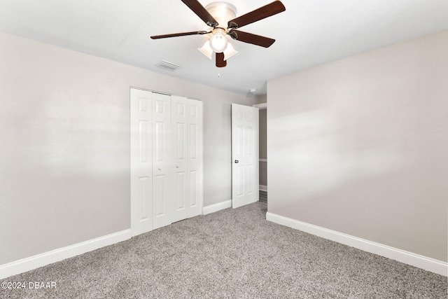 unfurnished bedroom featuring ceiling fan, carpet floors, and a closet