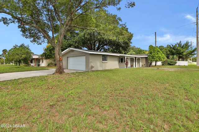 single story home featuring a front lawn and a garage