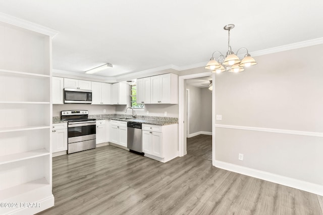 kitchen with light wood-type flooring, stainless steel appliances, and white cabinetry