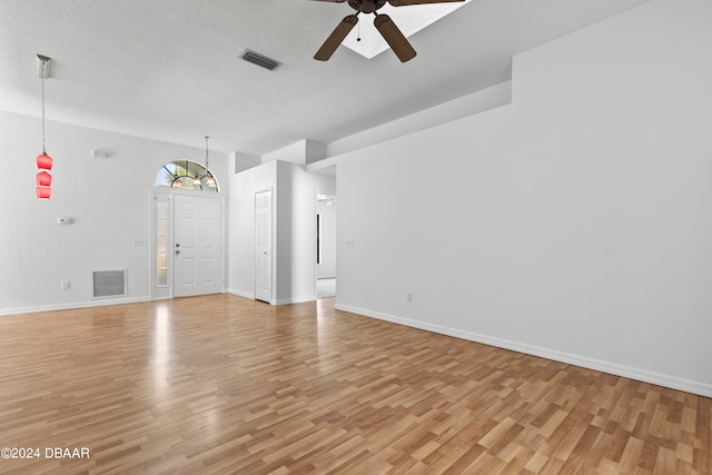 3864 Long Grove Ln, Port Orange, FL 32129 - unfurnished living room featuring a textured ceiling, light hardwood / wood-style flooring, and ceiling fan