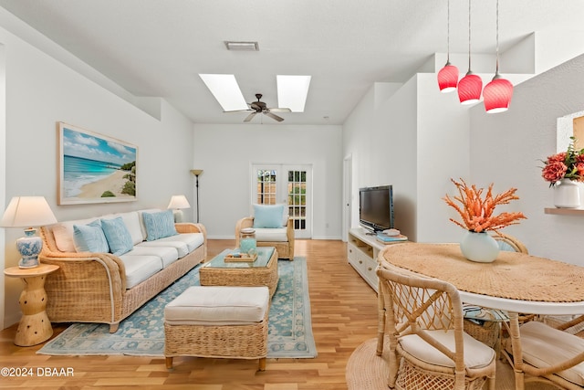 3864 Long Grove Ln, Port Orange, FL 32129 - unfurnished living room featuring a skylight, french doors, light hardwood / wood-style floors, and ceiling fan with notable chandelier