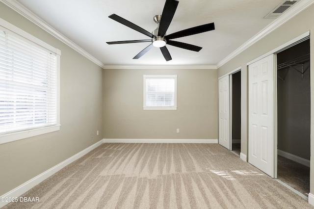 unfurnished bedroom with carpet, ceiling fan, and ornamental molding