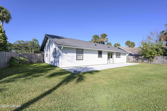 back of property featuring a yard and a patio