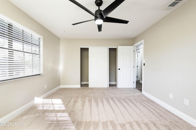 unfurnished bedroom featuring ceiling fan, carpet floors, and a closet