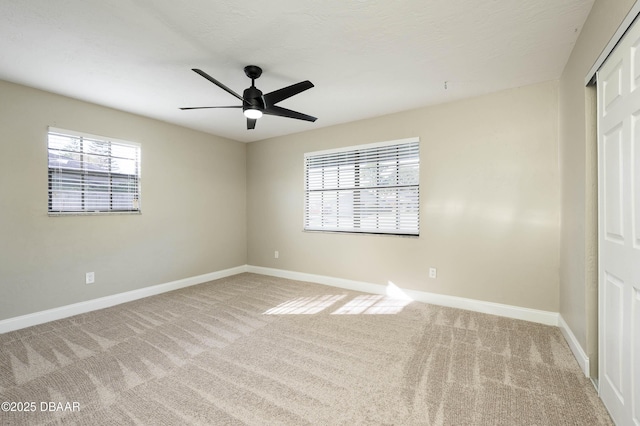 unfurnished bedroom with carpet, a closet, and ceiling fan