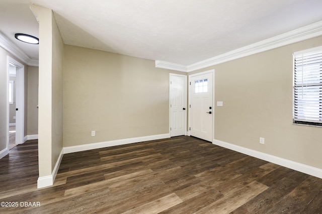 entrance foyer featuring a healthy amount of sunlight, dark hardwood / wood-style flooring, and ornamental molding