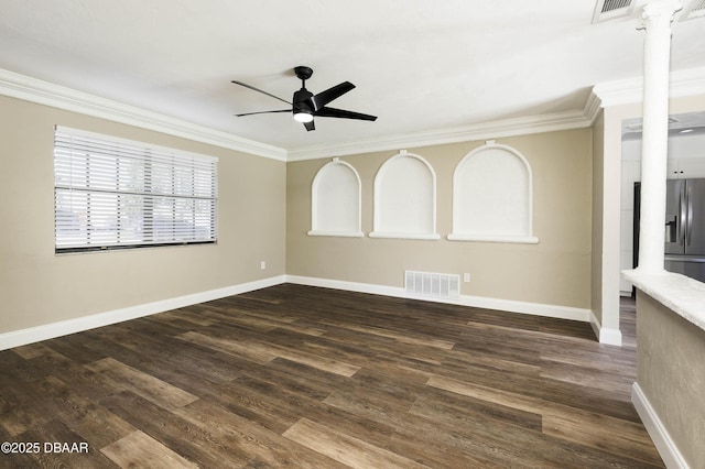 unfurnished room featuring ceiling fan, ornate columns, and crown molding