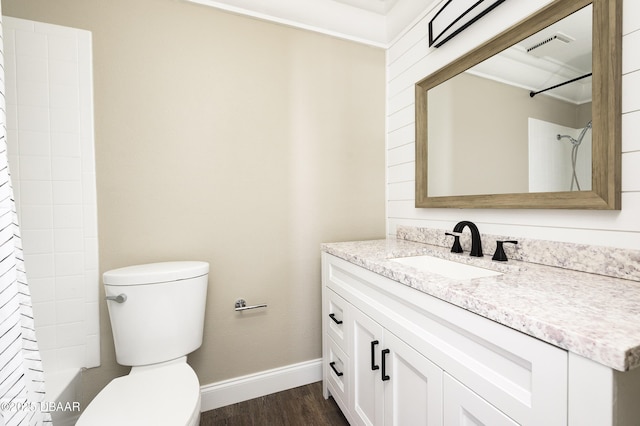 full bathroom with hardwood / wood-style floors, vanity, toilet, and bathing tub / shower combination