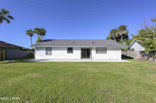 back of property featuring a patio area and a yard