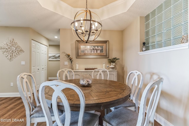 4672 Riverwalk Village Ct Unit 8203, Ponce Inlet, FL 32127 - dining room with baseboards, an inviting chandelier, and wood finished floors