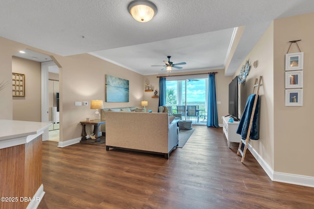 4672 Riverwalk Village Ct Unit 8203, Ponce Inlet, FL 32127 - living area with arched walkways, ornamental molding, a ceiling fan, baseboards, and dark wood-style floors