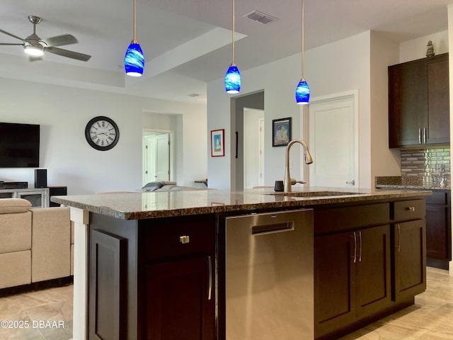 kitchen with a raised ceiling, open floor plan, a sink, dark brown cabinetry, and dishwasher