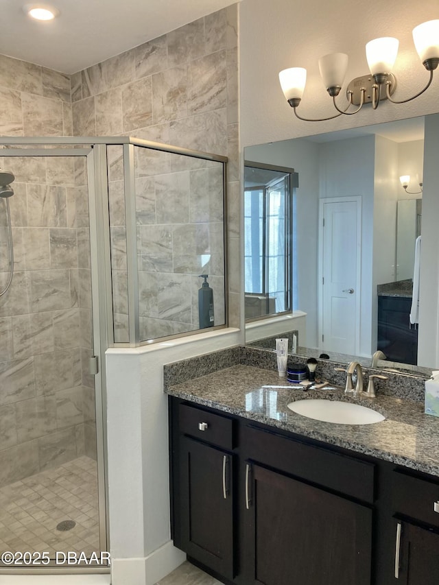 bathroom with a shower stall and vanity