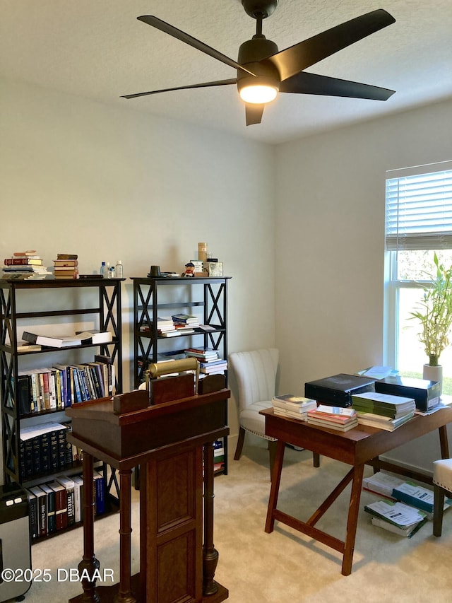 office with a ceiling fan and light colored carpet