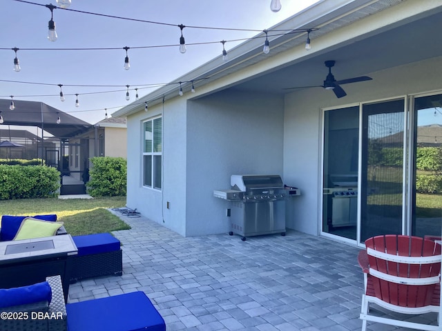 view of patio with a grill and ceiling fan