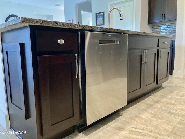 kitchen with dishwasher, tasteful backsplash, and light stone countertops