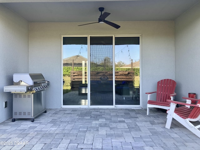 view of patio / terrace featuring area for grilling and a ceiling fan