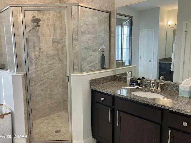 bathroom featuring a stall shower and vanity