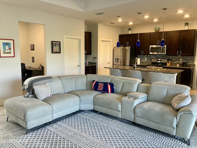 living area featuring recessed lighting and visible vents