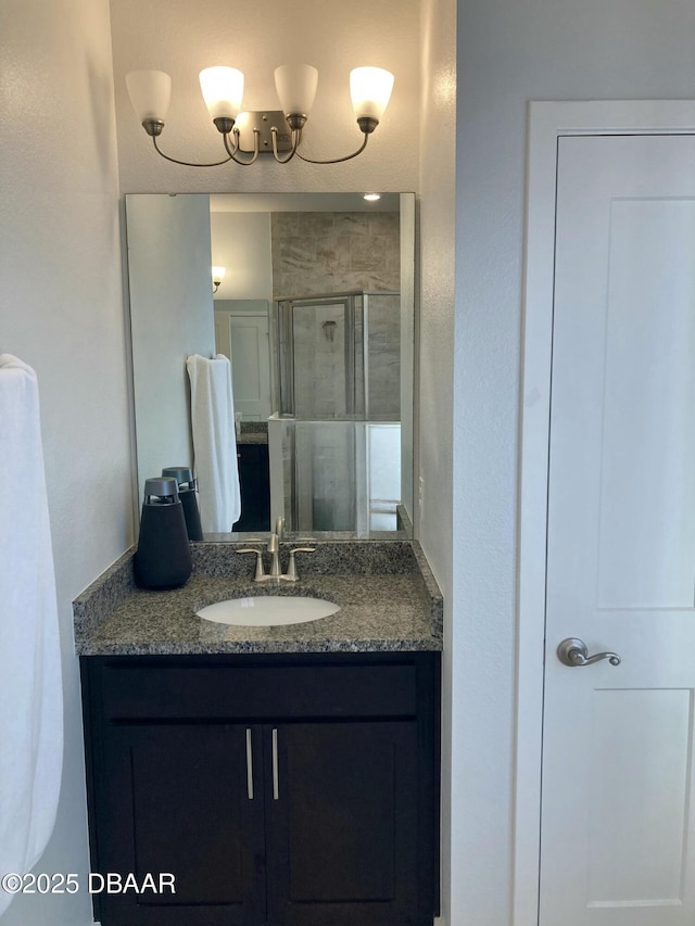 full bathroom with a stall shower and vanity